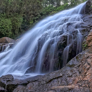 Enjoy serene views of cascading waterfalls near De Castle Villa, surrounded by lush greenery and nature