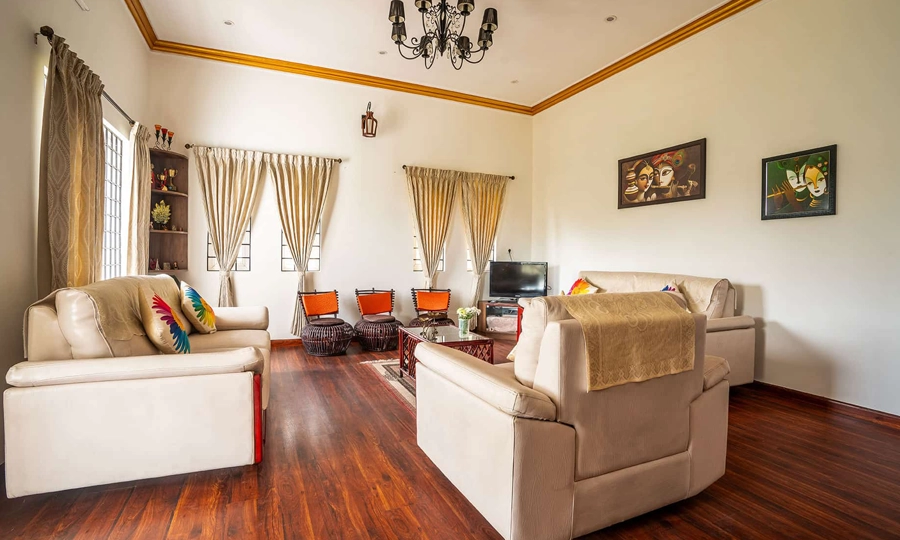 Relax in living area designed for maximum comfort, warm gatherings, and soothing green views in Kotagiri.