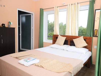 Enjoy a comfortable stay in a cozy bedroom at a luxury homestay in Coonoor surrounded by nature