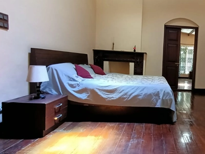 Stay in a traditional-style bedroom at Shantiniketan Villa in Coonoor with vintage decor and cozy comfort