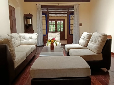 Spacious living hall with heritage-style interiors at Shantiniketan Villa, ideal for relaxing group stays