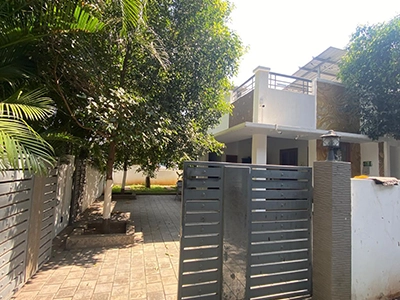 Walk through a scenic entrance surrounded by greenery and feel the atmosphere at farmhouse in Sulur.