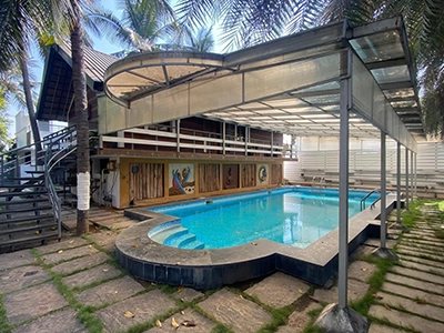 Relax at a peaceful private farmhouse stay in Sulur, featuring a swimming pool and lush greenery.