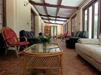Spacious living hall with heritage-style interiors at Shantiniketan Villa, ideal for relaxing group stays