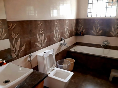 Step into a spotless luxury bathroom with a modern tub, refreshing shower, toilet facility in Kotagiri.