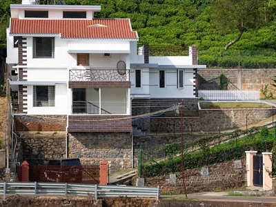 Fort-inspired space offering spacious bedrooms, pristine baths, and scenic mountain views in Kotagiri.