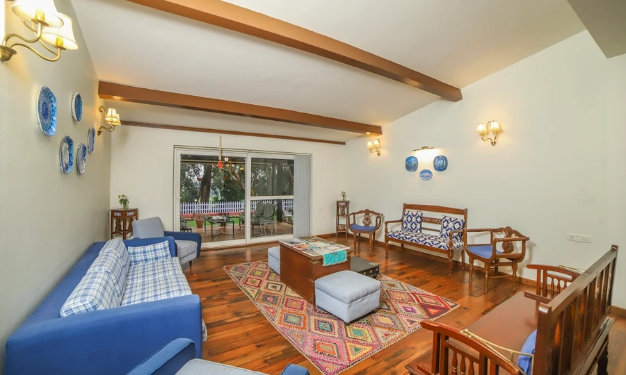 Relax in living area designed for maximum comfort, warm gatherings, and soothing green views in Kotagiri.