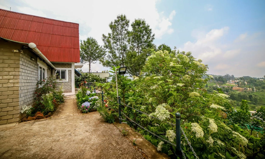 Experience a serene hilltop villa stay at Chalet Mon Ami Kotagiri with stunning views and luxury comfort.