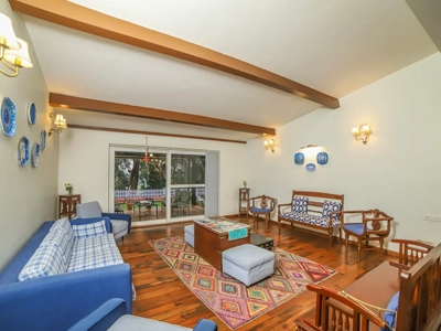 Relax in living area designed for maximum comfort, warm gatherings, and soothing green views in Kotagiri.