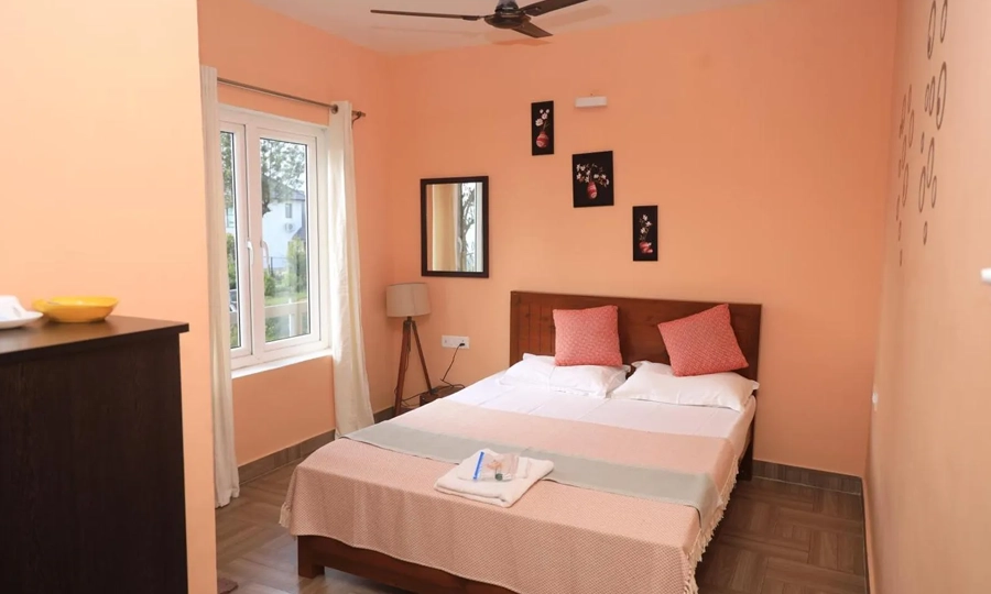 Book a luxury villa and homestay in Coonoor featuring a cozy bedroom for a peaceful hill stay