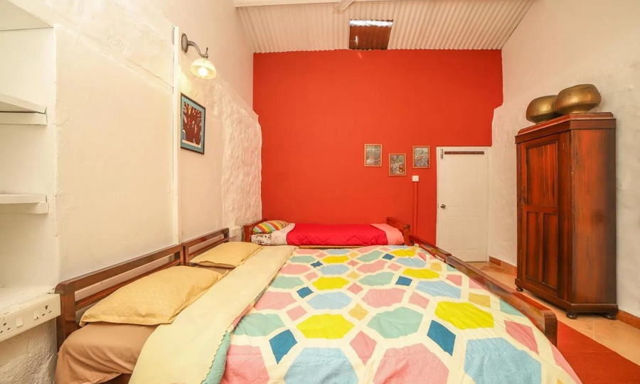 Experience comfort and rustic charm in a heritage stone villa bedroom at Rico Retreat in Kotagiri