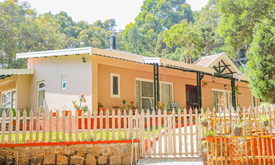 Fort-inspired space offering spacious bedrooms, pristine baths, and scenic mountain views in Kotagiri.