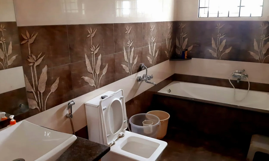 Step into a spotless luxury bathroom with a modern tub, refreshing shower, toilet facility in Kotagiri.