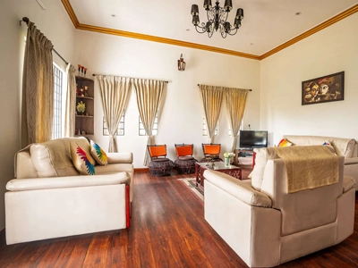 Relax in living area designed for maximum comfort, warm gatherings, and soothing green views in Kotagiri.