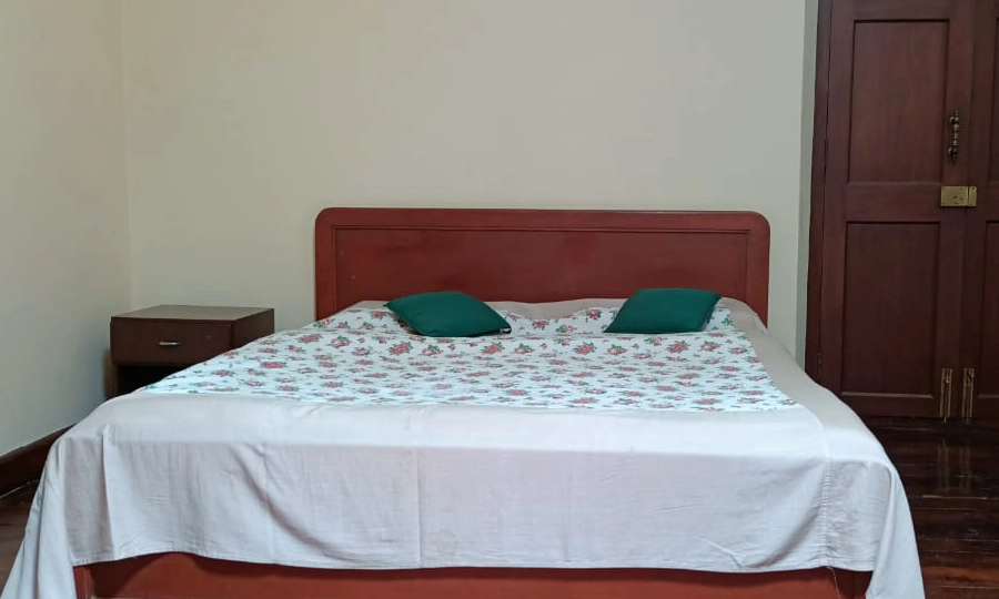 Experience traditional architecture and heritage interiors in the cozy bedroom at Shantiniketan, Coonoor