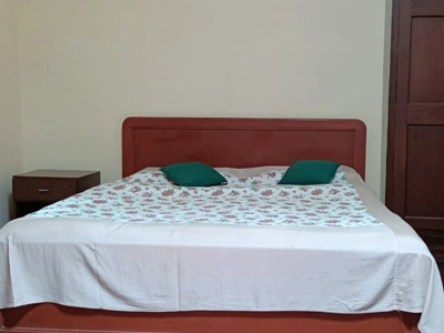 Stay in a traditional-style bedroom at Shantiniketan Villa in Coonoor with vintage decor and cozy comfort
