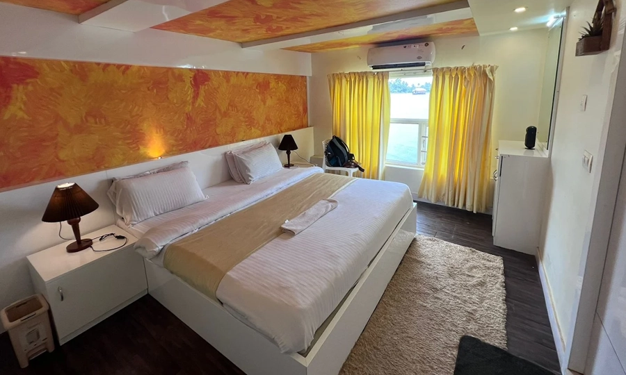 Relax in a comfortable bedroom on an Alleppey houseboat with serene views and peaceful night stay experience
